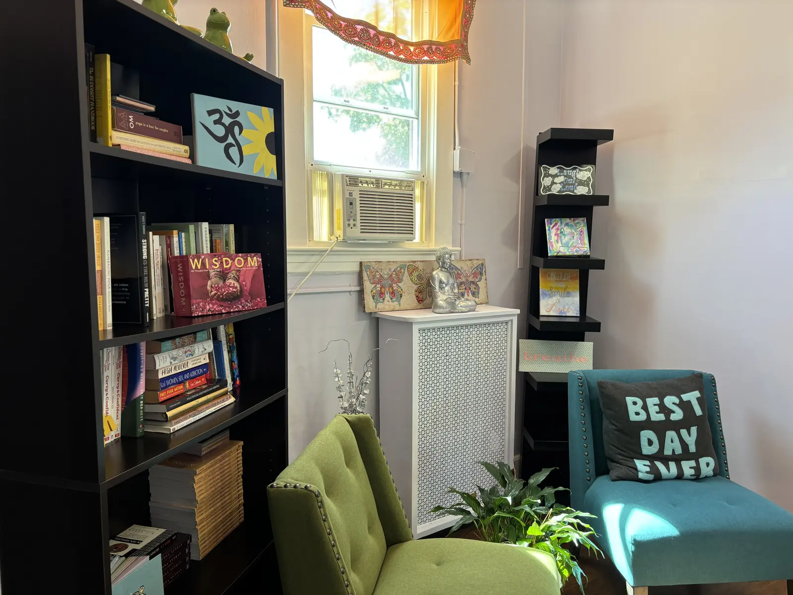 A reading nook with green armchairs
